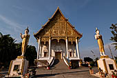 Vientiane, Laos - Pha That Luang, the elegant structure, Wat That Luang Neua, with a very ornate front faade fronted by two tall standing Buddha statues. 